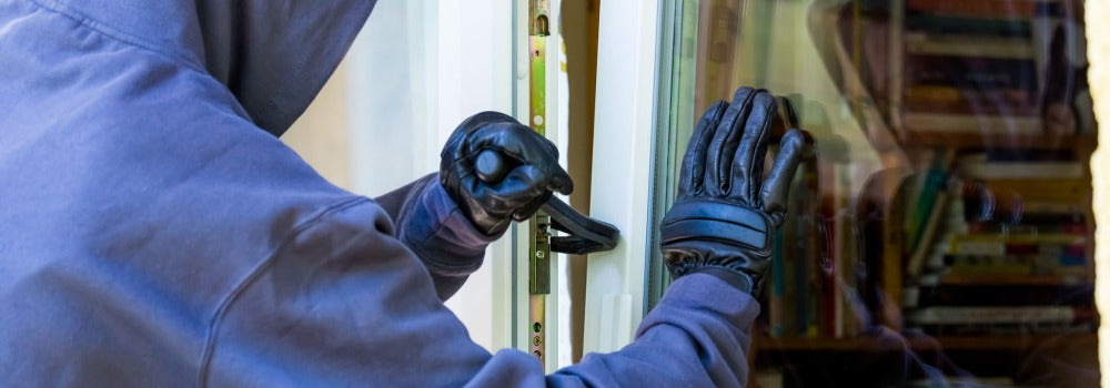 Thief using a crowbar to break in