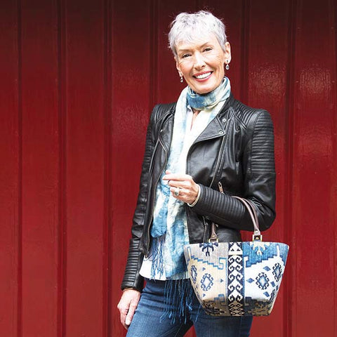 Woman holding the Navy Canvas Handbag with a Kilim print by Umpie Handbags