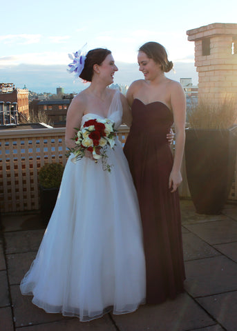 The Feathered Head Bride of the Month wearing white purple wedding feather fascinator headpiece