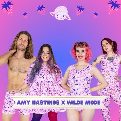 a pink and purple background with strawberries and a lambs head, with 4 models in their underwear which is designed by amy hastings. The print is light pink with drawings of cupid, lambs and other delightful drawings.