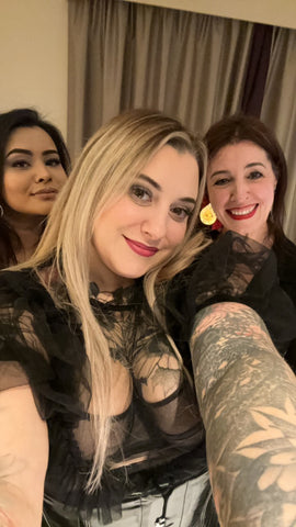 Debz, Helen and Anabel are taking a selfie. They are all dressed up in Black and full make up about to go on a night out and smiling to the camera.