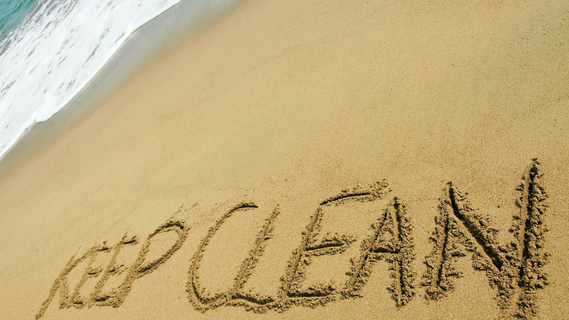 Writing on the sand says KEEP CLEAN