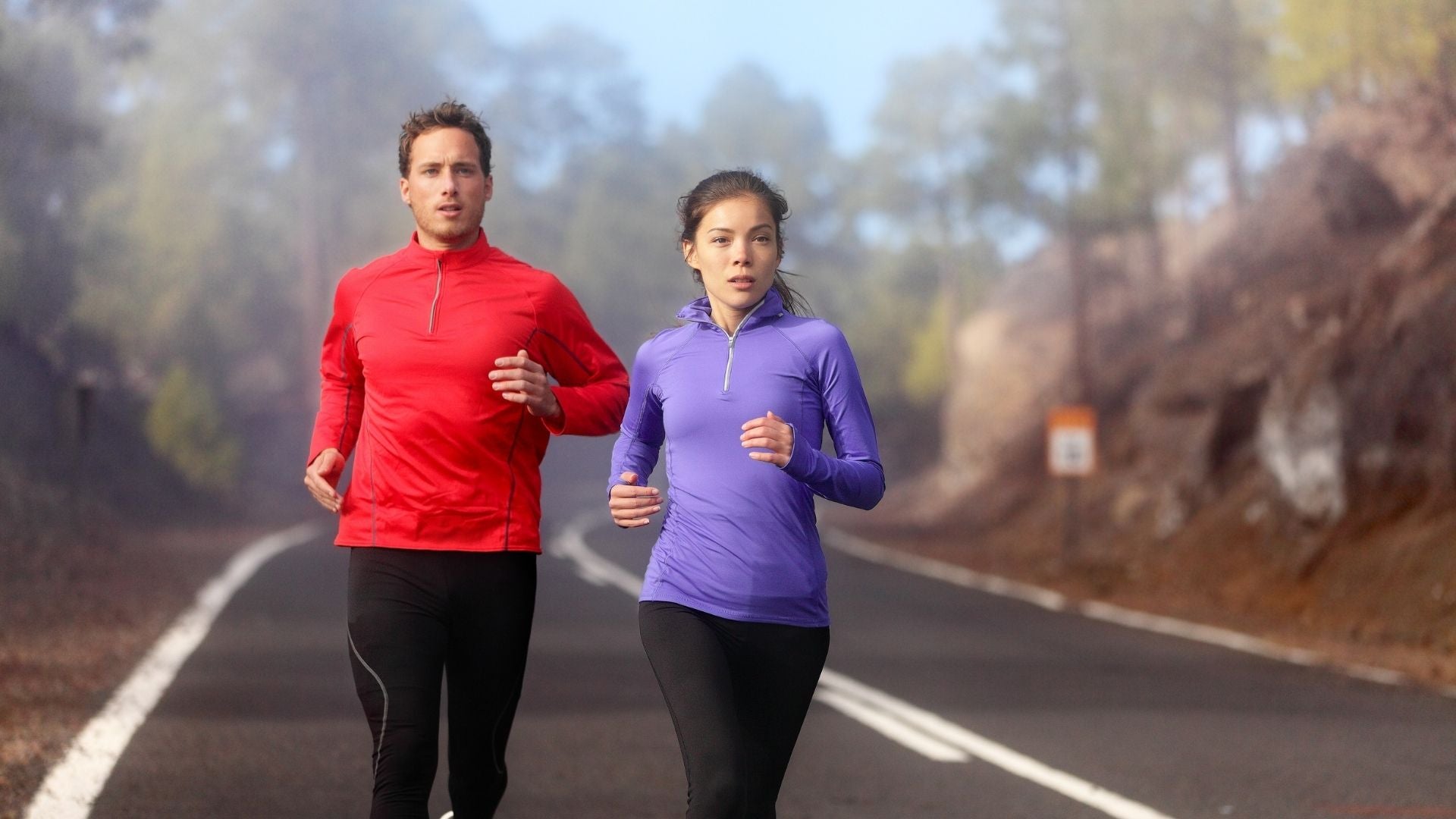 A man and a woman jogging together in winter