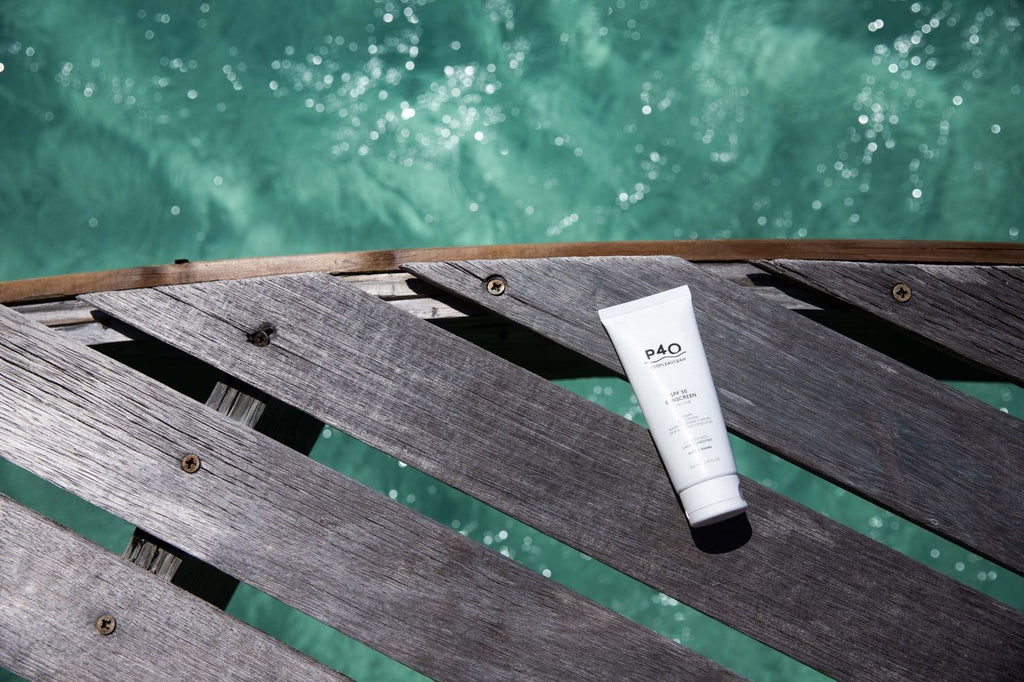 a tube of suncream on a wooden pier
