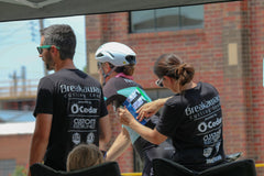 BCT coaches Tiffany and Brad assist a rider with their race number