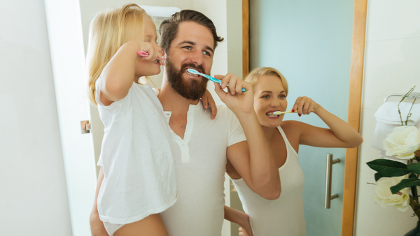 Family brushing their teeth