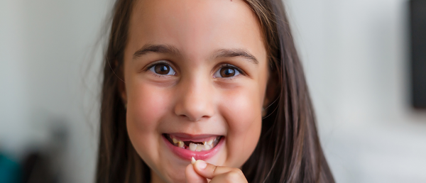 Child holding lost tooth