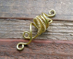 A side view of a Small Woven Brass Dread Bead.