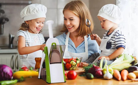 mother who cooks with her two small children and uses the multifunctional vegetable slicer together with them