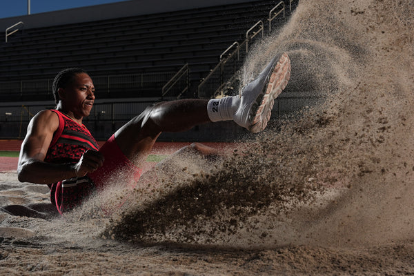 an athlete lands a long jump