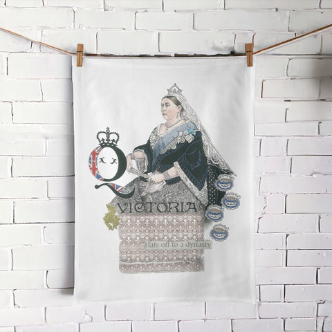 Queen Victoria oversize Tea Towel hanging against a white brick wall