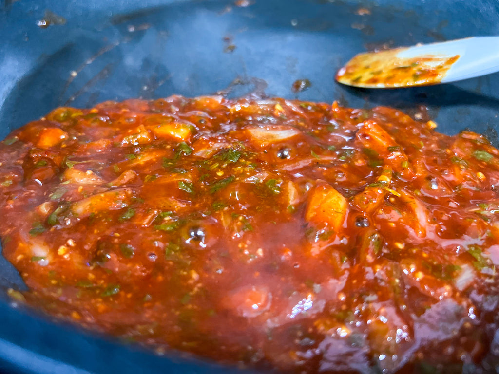 reduced guajillo, boullion, garlic, shallot, cilantro, tequila, lime juice, and lime zest in a pan