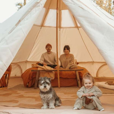 family and toddler baby in glamping bell tent