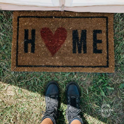 doormat in front of tent door and boots