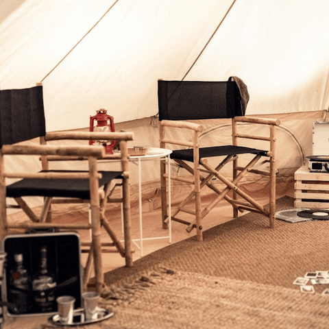 camp chairs and lantern inside family camping tent