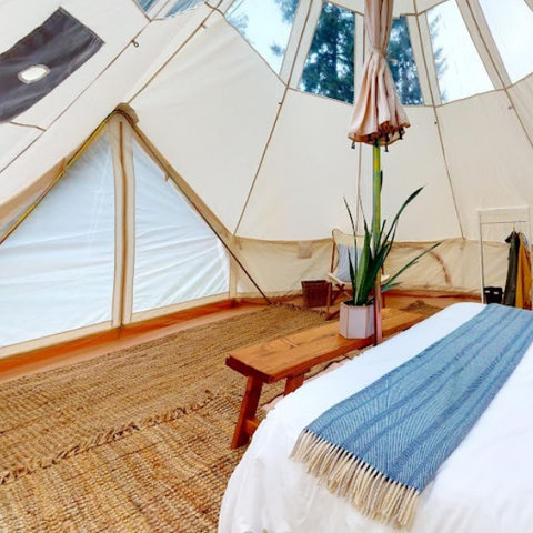 canvas bell tent with windows and bed