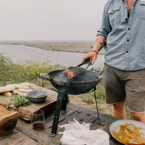 cast iron grill by river camp