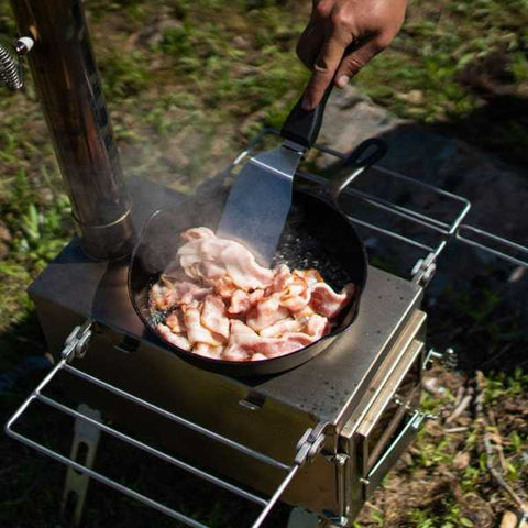 wood stove cooking bacon on it