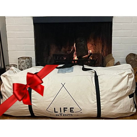 tent gift with a bow on it in front of a fireplace