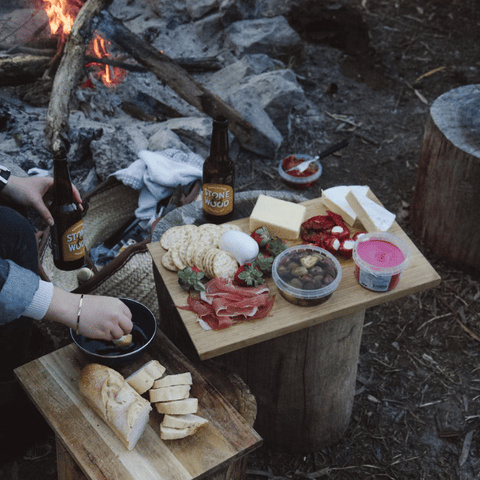 romantic camping meal by a fire with bread