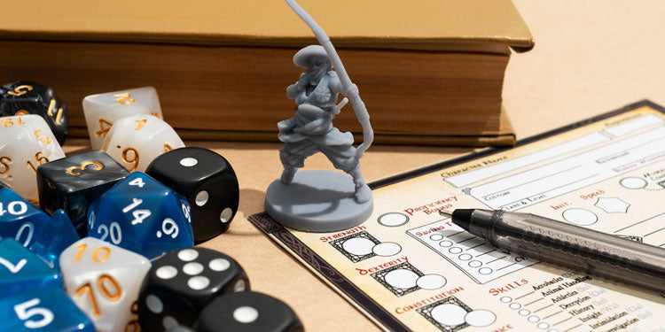 close up of board game elements and rolling dice; a box in the background