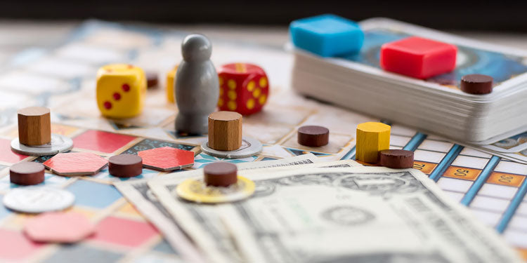 closeup image with board game elements and accessories, and dollar bills