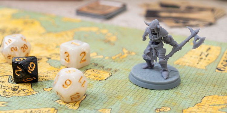 four rolling dice on a board game board, standing next to them are a small detailed warrior figurine