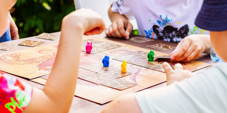 a clode up of children having fun while playing a board game