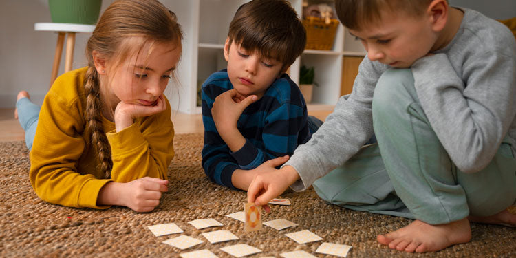 children, aged about 7-8 years are having fun while playing a board game, photo taken from a lower angle