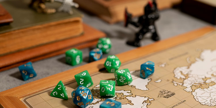 close up of elements of a board game, rolling dice, map, figures