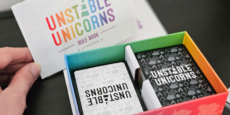 box and cards of the card game unstable unicorns