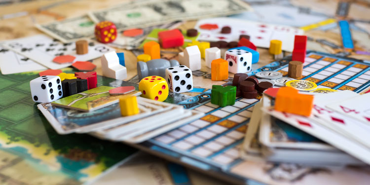 closeup of dice and other board game accessories on a board game board
