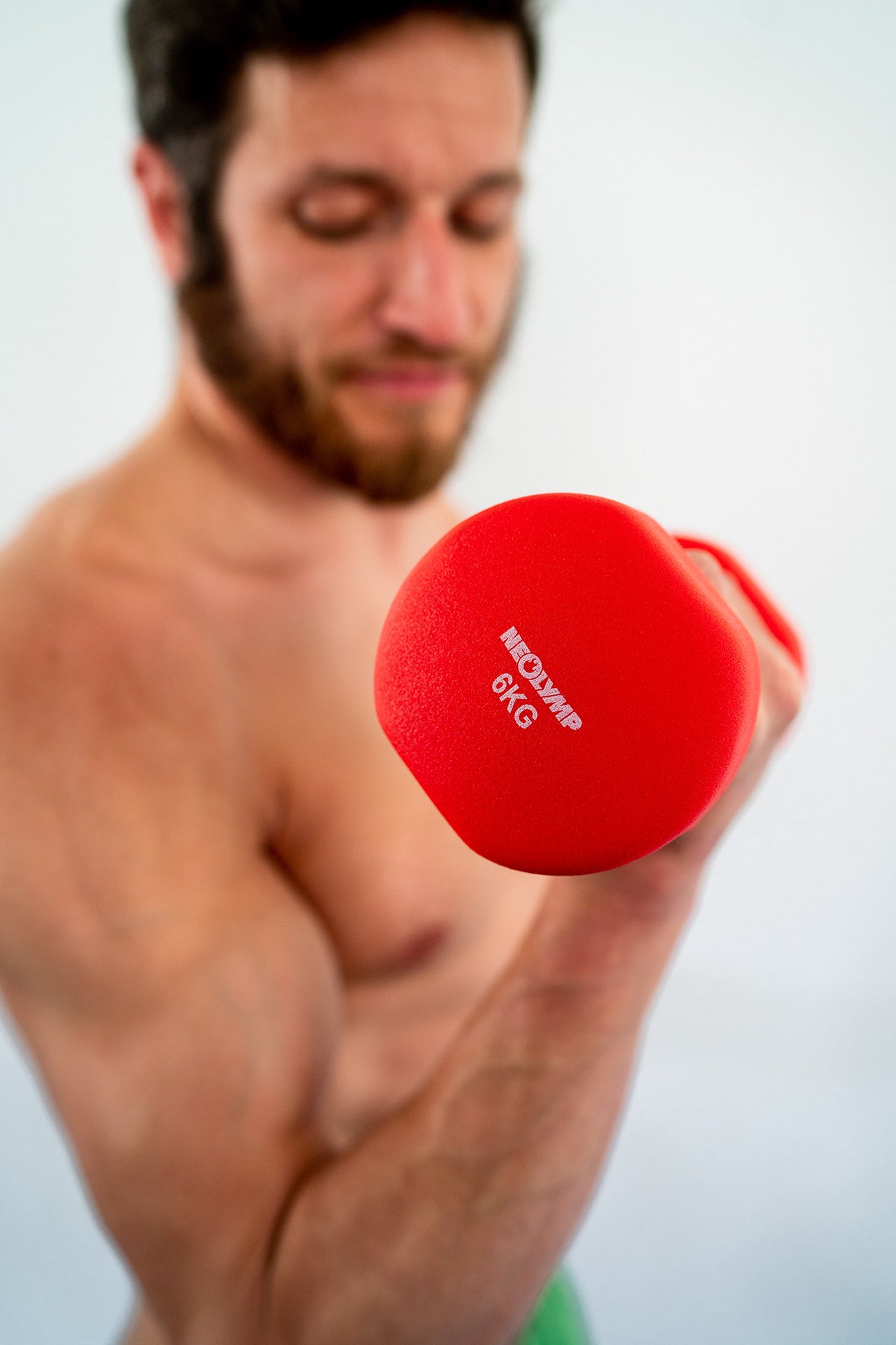 Man training with neoprene dumbbell