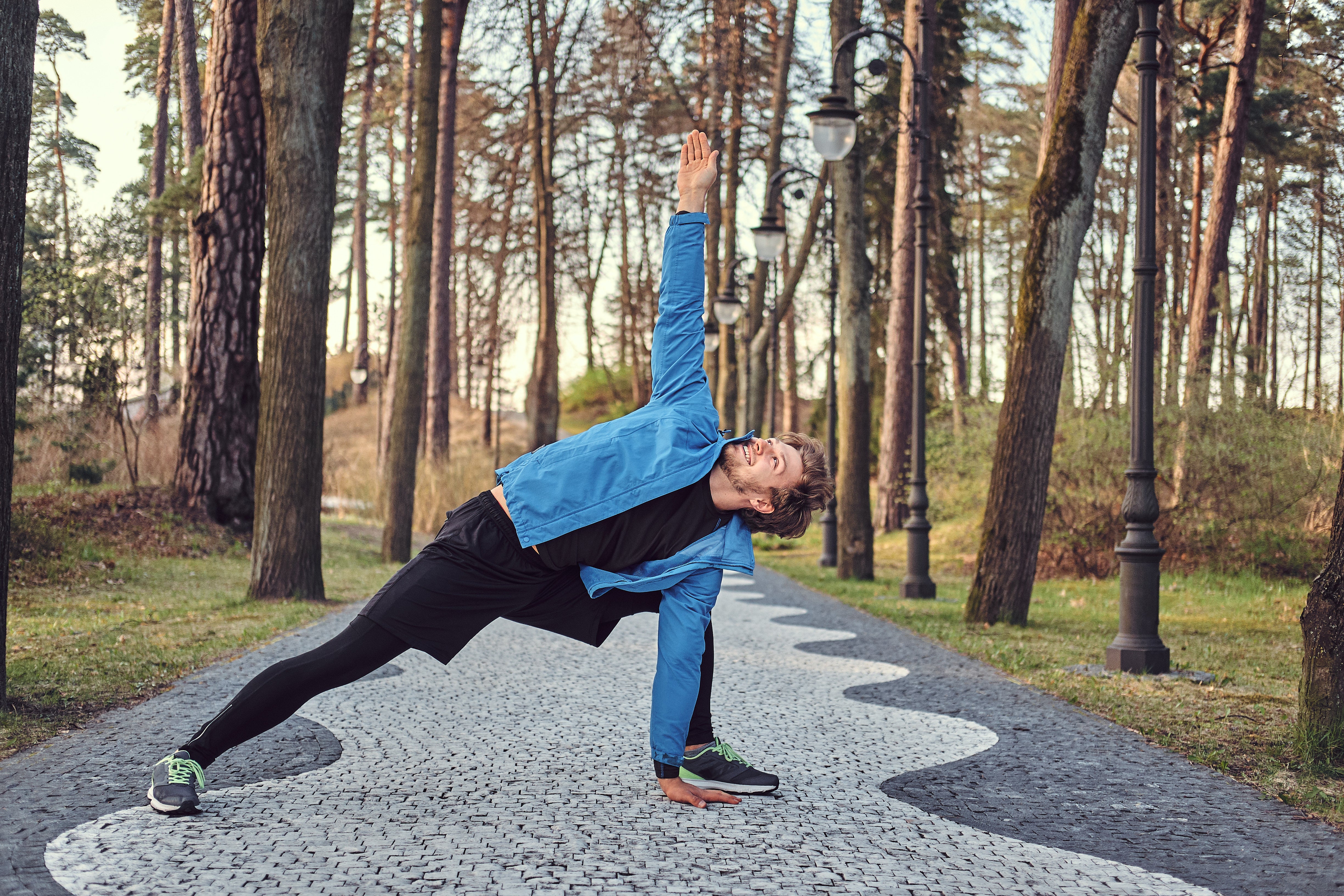 Man stretching in park