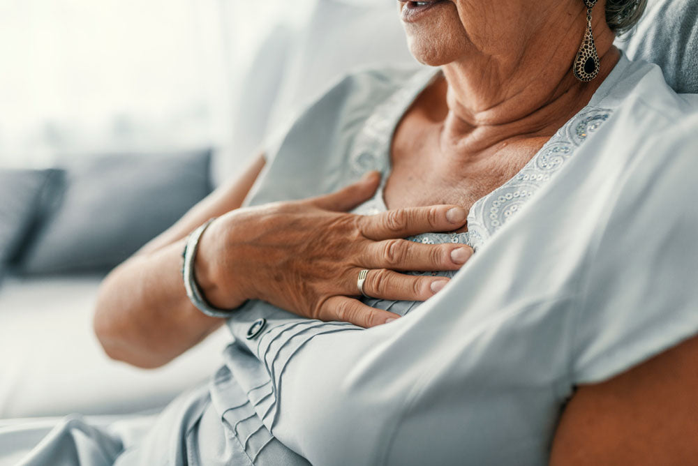 Senior woman suffering from chest discomfort symptoms as a result of GERD.