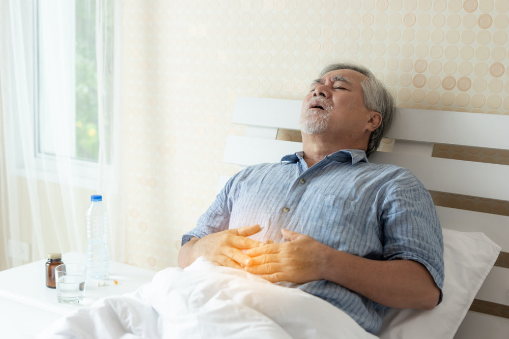 Older man in pain while lying in bed