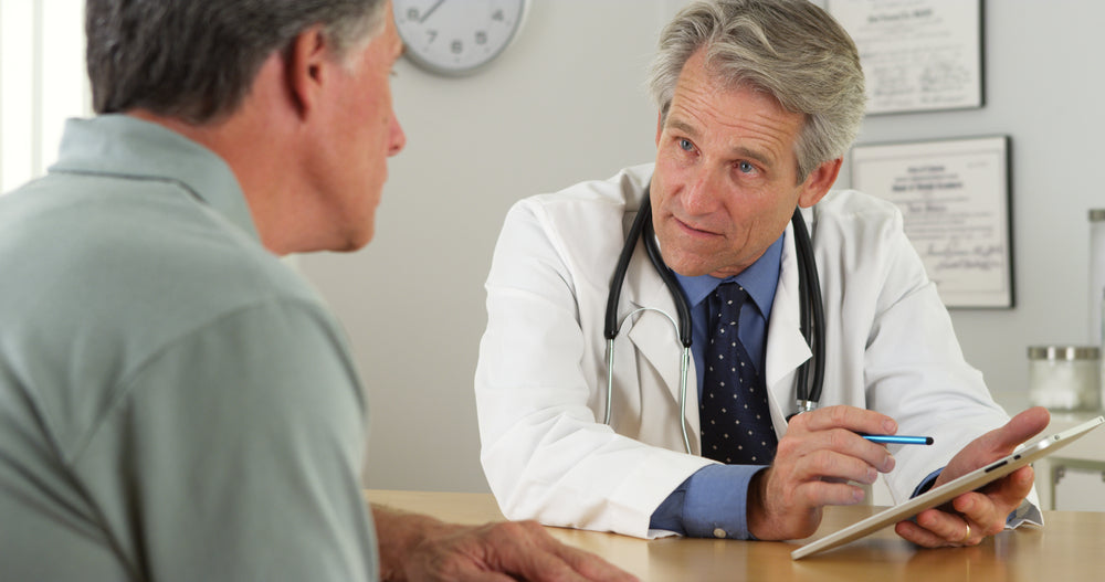 man visiting doctors office for gerd symptoms