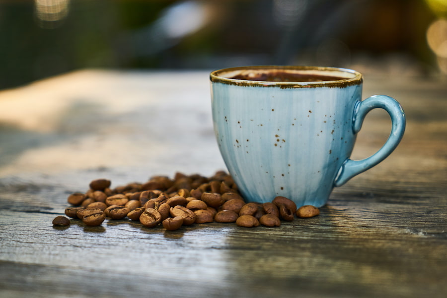 An image of coffee mug and coffee beans