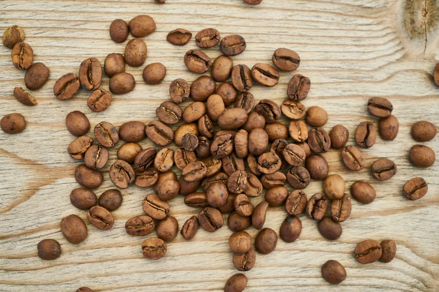 An image of coffee beans on a wood surface