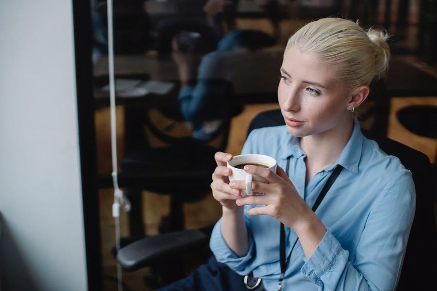 Woman calmly drinking her CBD infused coffee