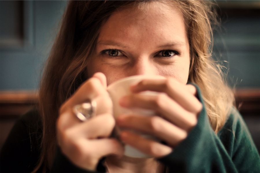 Woman taking a sip of her cup of hemp tea