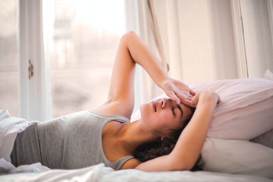 Woman preparing to sleep in bed