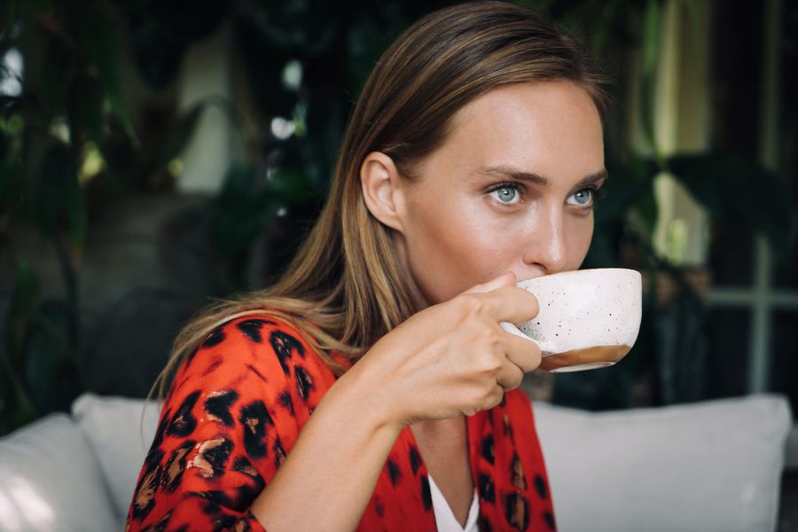 Woman taking a sip of her CBD coffee