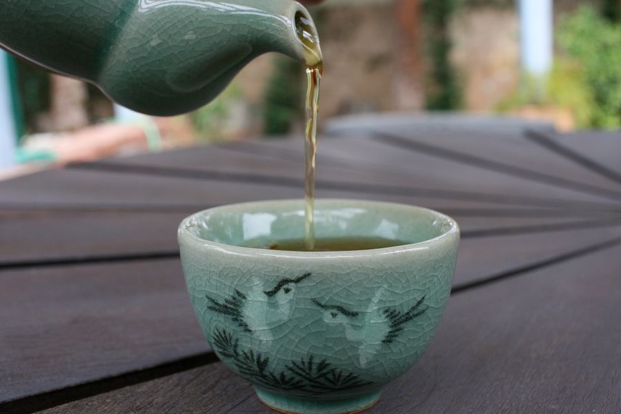 Tea being poured on a cup