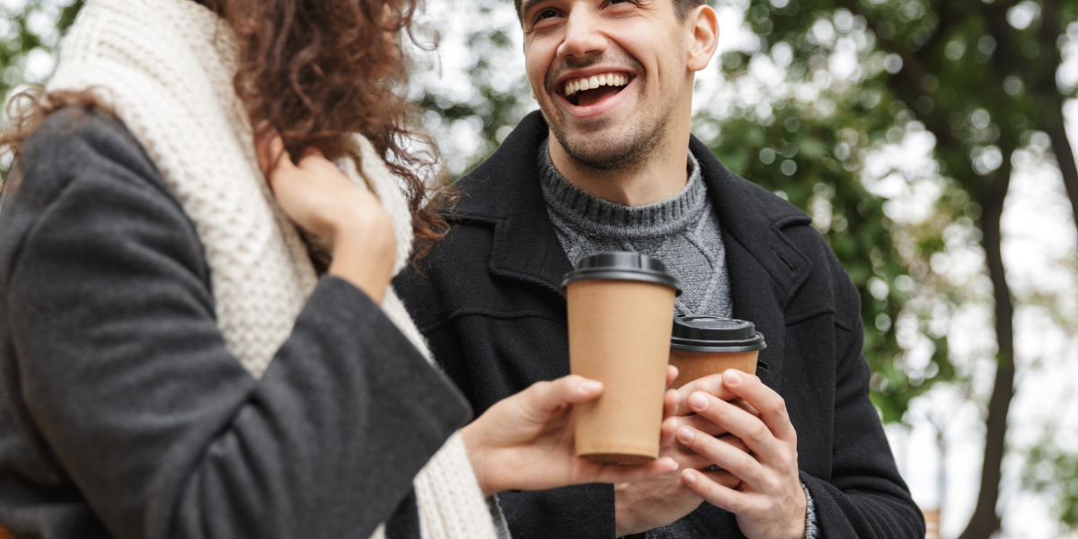 Two people enjoying a takeaway coffee