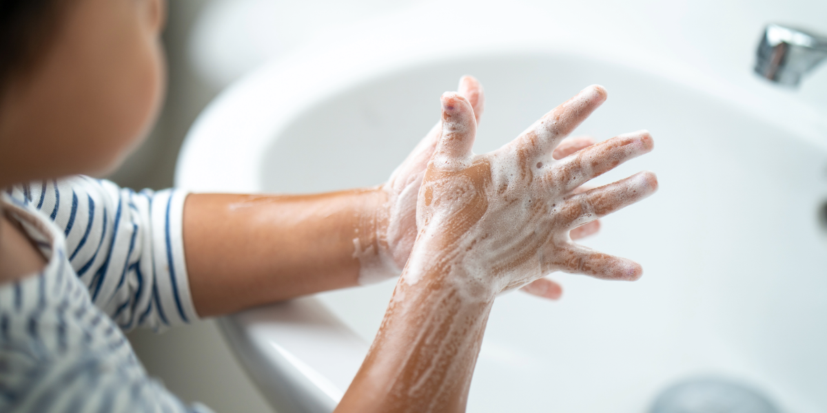 Child washing their hands