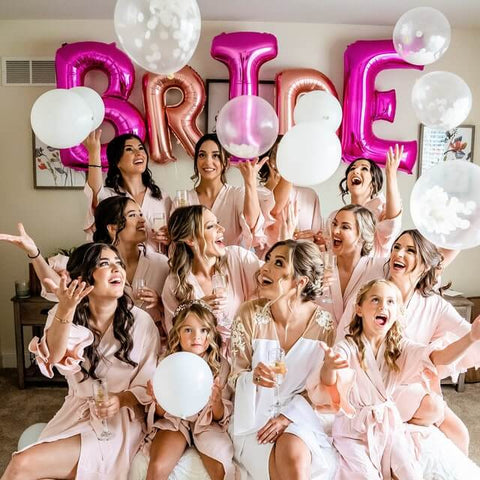 Bridesmaids in white and blush robes