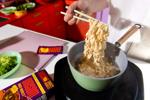 image of knife-shaved noodles being boiled