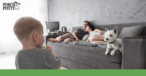 A family relaxes on the sofa with their new puppy