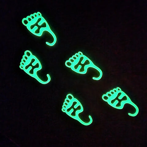 Foot shaped headlamp hangers glowing in the dark
